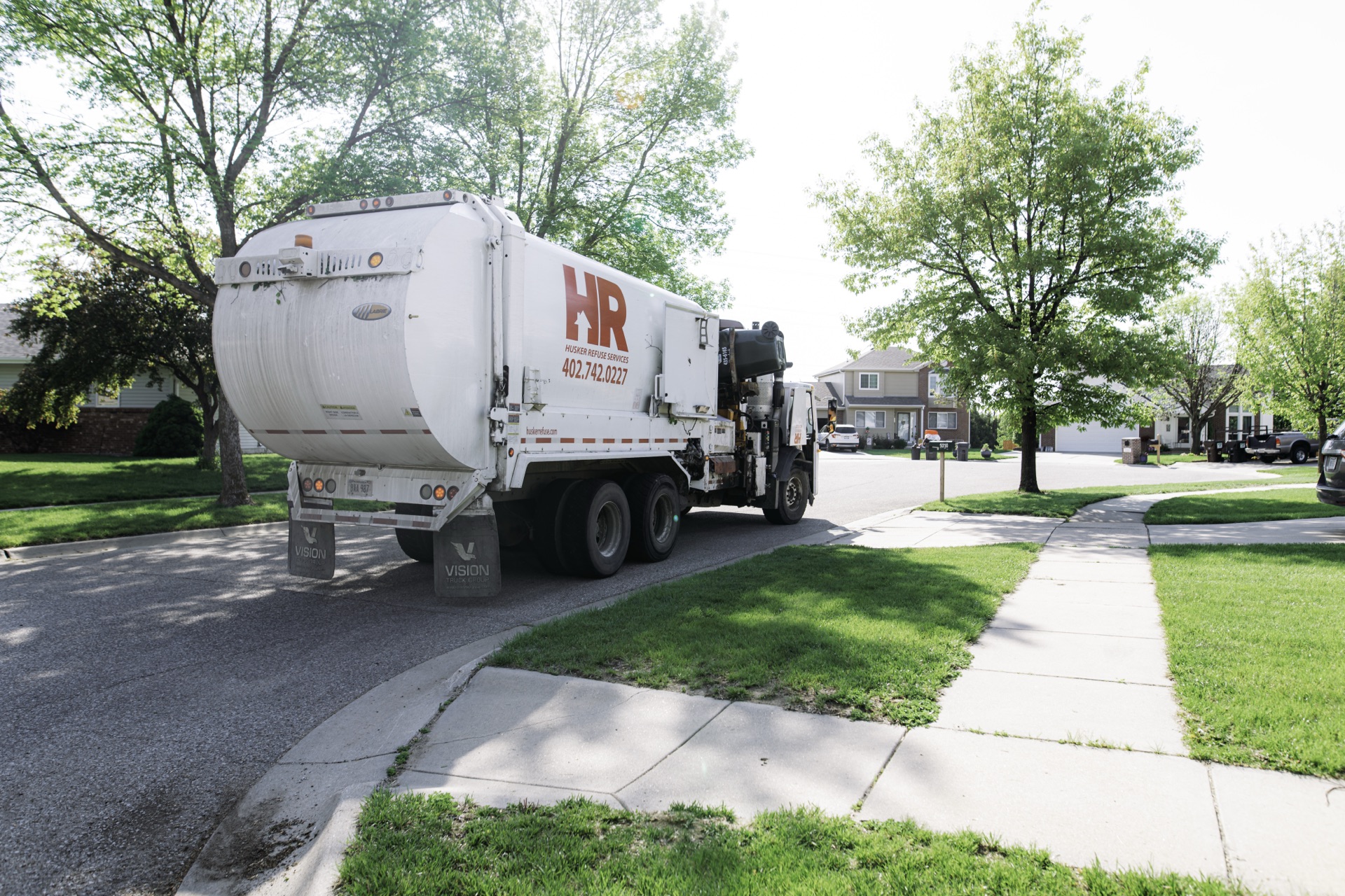 Husker Refuse automated collection truck servicing a Lincoln neighborhood
