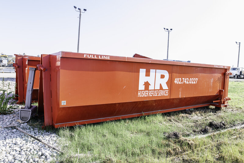 Husker Refuse roll-off dumpster delivery truck